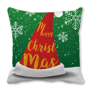 Détail d'une housse de coussin de Noël avec bonnet rouge et texte festif doré