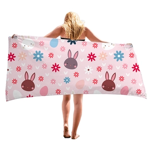 Pink beach towel with cute cartoon rabbit and colorful floral patterns for beach vacation