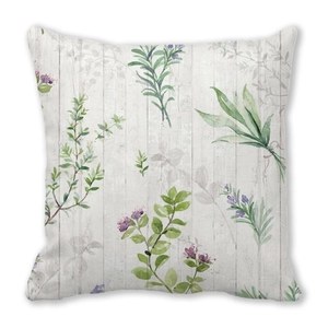 Detail of floral peach skin cushion cover with green leaves and wood grain texture