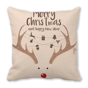 Detail of Christmas pillow cover with reindeer motif and holiday greetings on linen fabric