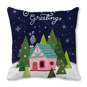 Close-up of festive Christmas pillowcase with Greetings text and winter house design