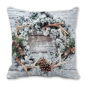 Detail of Christmas pillowcase with pine wreath, antlers and cones on wood texture