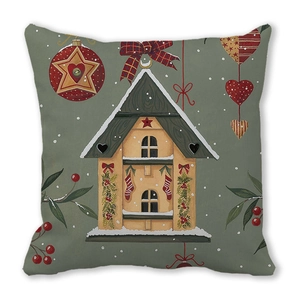 Detailansicht eines Kissenbezugs mit verschneitem Haus und weihnachtlichen Motiven