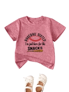 Detail of pink cotton baby t-shirt with baseball graphic and white bow shoes on top