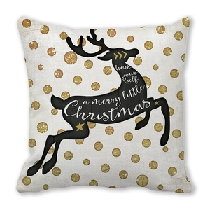 Macro shot of linen Christmas pillowcase featuring golden polka dots and reindeer silhouette