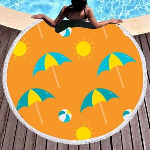 Thick round beach towel with tassels featuring sun and beach ball prints by a pool