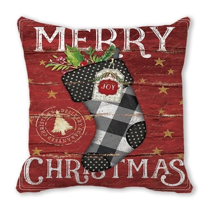 Detail of square Christmas pillowcase featuring a festive sock over a red wood texture