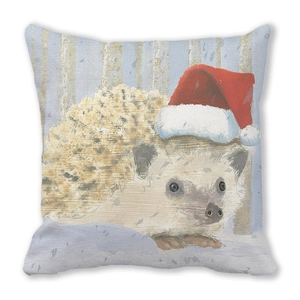Close-up of peach skin cushion cover with cute hedgehog wearing a red Santa hat