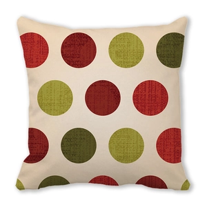 Macro detail of square Christmas cushion with red and green vintage polka dot pattern
