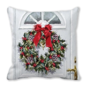 Detail of Christmas pillow cover with oil painting style wreath on a white door