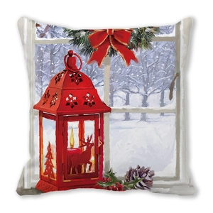 Detail of Christmas cushion cover with lantern, reindeer silhouette, and festive holly
