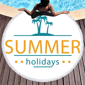 Round summer beach towel with palm tree pattern, orange lettering and white tassels