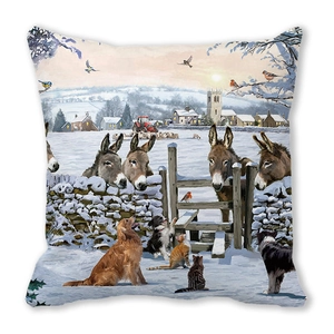 Close-up of winter snow scene cushion cover featuring animals and village scenery