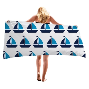Microfiber beach towel with blue sailboat patterns held by model for summer vacation