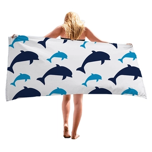 Thick microfiber beach towel featuring blue cartoon whale silhouettes for seaside vacations