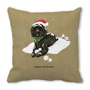 Détail de la housse de coussin peau de pêche avec chien de Noël et texte de fête