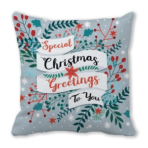 Detail of Christmas pillow cover with pine branches berries and seasonal greetings text