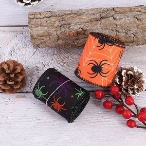 Halloween spider pattern ribbon set for DIY party decorations on a rustic wood surface