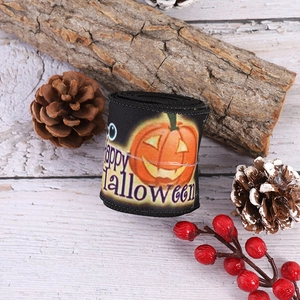 Halloween black ribbon roll with pumpkin patterns and Happy Halloween text on wood background