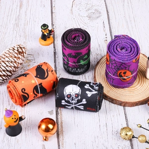 Halloween decorative ribbon set with pumpkin, skull, and bat prints on textured fabric