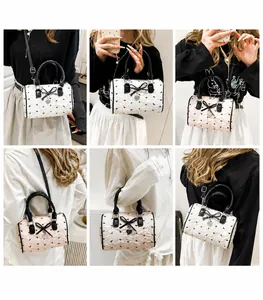 Detailed views of balletcore pink boston bag showing handheld and crossbody styles