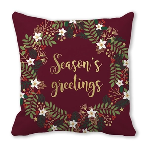 Close-up of Season's Greetings lettering on a festive burgundy Christmas pillowcase