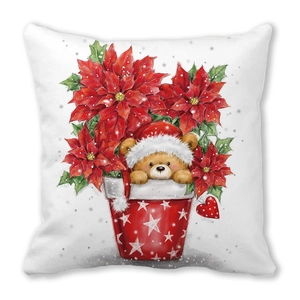 Macro detail of Christmas pillow cover with teddy bear print and festive red poinsettia