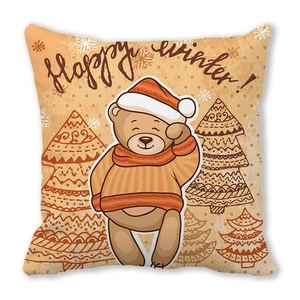 Detail van kussensloop met cartoonbeer, tekst Happy Winter en perzikhuid oppervlak