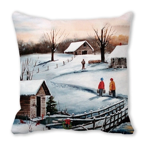Close-up of peach skin throw pillow featuring a cozy winter village snow scene print