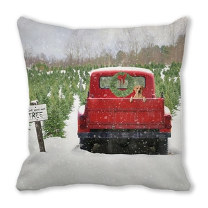 Close-up of Christmas cushion cover featuring red truck and golden retriever print