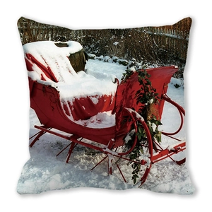 Detail of Christmas pillow cover with vintage red sled and winter snow scene print