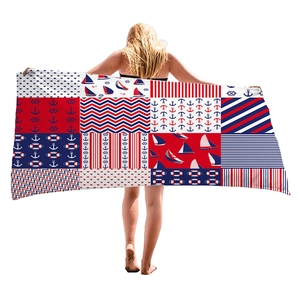 Microfiber beach towel with nautical patterns of anchors and sailboats in red, white and blue