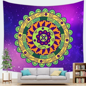 Starry sky mandala tapestry with bohemian geometric patterns hanging over a living room sofa