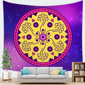 Detail of starry mandala tapestry with vibrant pink and yellow patterns over a sofa