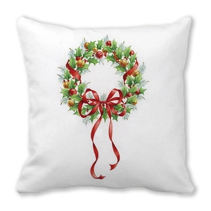 Detailed close-up of a festive Christmas wreath print on a square white cushion cover