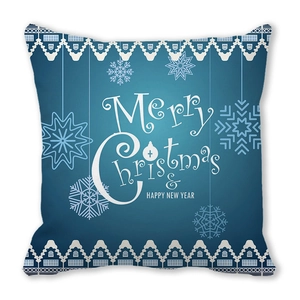 Close-up of blue Christmas pillowcase with white snowflake patterns and festive text