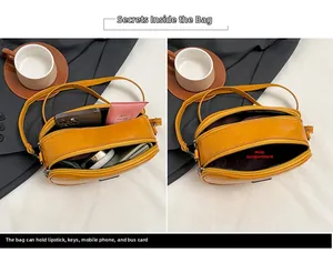 Detail view of the yellow mini crossbody bag showing dual zipper structure and internal capacity