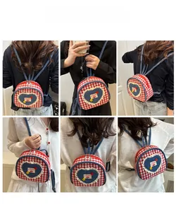 Detail shots of girls red gingham mini backpack with denim heart and cherry embroidery