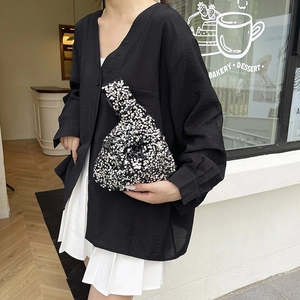 Sparkling silver sequin wristlet handbag for women featuring a stylish knot strap design