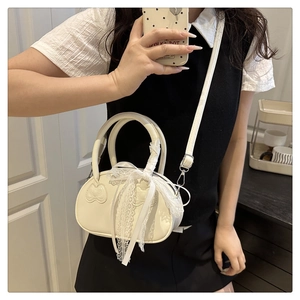 Close-up of white PU leather bag with Hello Kitty embossing and lace bow detail