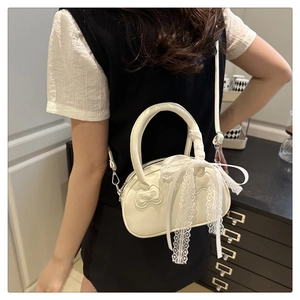 Detailed back view of a white lace shoulder bag with a 3D bow on a female model