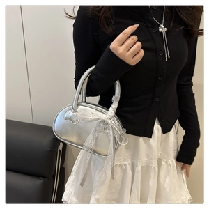 Silver metallic handbag with large white lace bow and satin handle detail