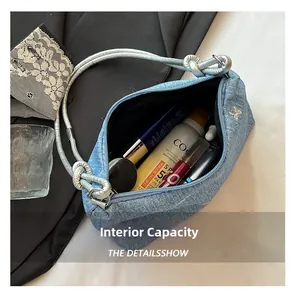 Macro shot of denim baguette bag interior showing capacity for daily cosmetics