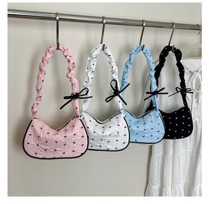 Detailed quilted nylon crescent bags with ribbon bows in pink, white, blue and black