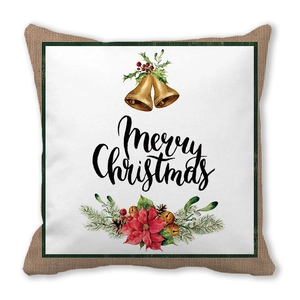 Detail of Christmas pillow cover featuring Merry Christmas script with festive holly and bells