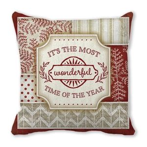 Close-up of peach skin fabric pillow cover with festive patchwork patterns and holiday text