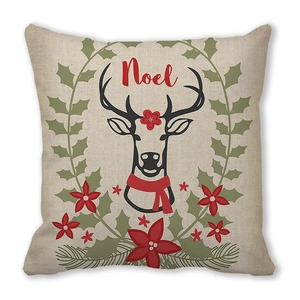 Detail of Christmas Noel reindeer cushion cover with holly and red floral patterns