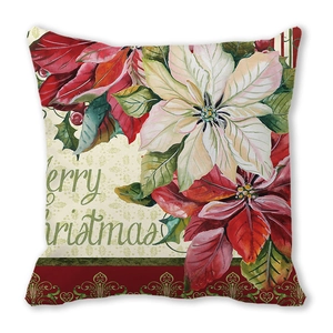 Detalle del estampado de flor de pascua y texto Merry Christmas en funda de cojín