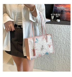 Detail of pink Chinese style tote bag featuring jacquard fabric and tassel