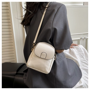 Close-up of stylish white crossbody phone bag with gold metal hooks and slim leather strap